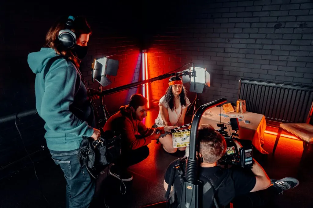 Here’s an SEO-friendly alt text for the image: Crew using audio equipment for filmmaking on a commercial set with LED lighting and camera gear.