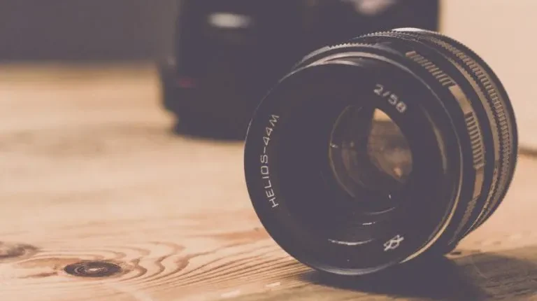 Helios-44M lens on wood table for film equipment rental insurance visuals