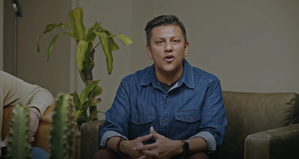 A cinematic interview lighting setup using a soft key light to create gentle, professional modeling on the subject's face as he speaks.
