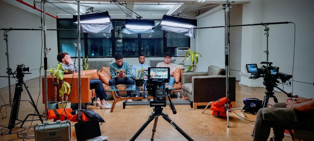 A behind-the-scenes look at the multi-person setup, showing the overhead grid of LED panels and multiple camera angles.